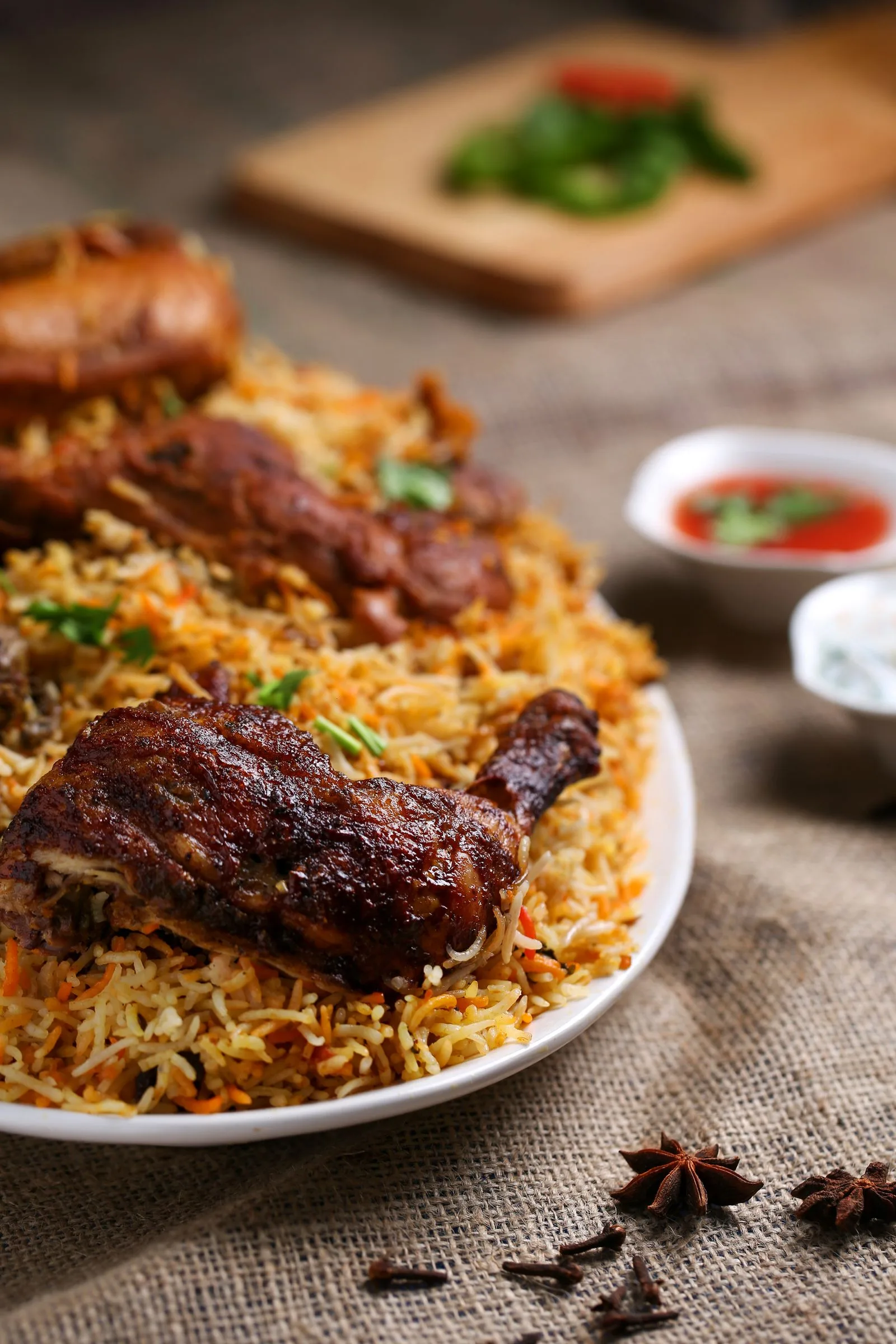 Chicken biryani with roasted spices on a serving platter.