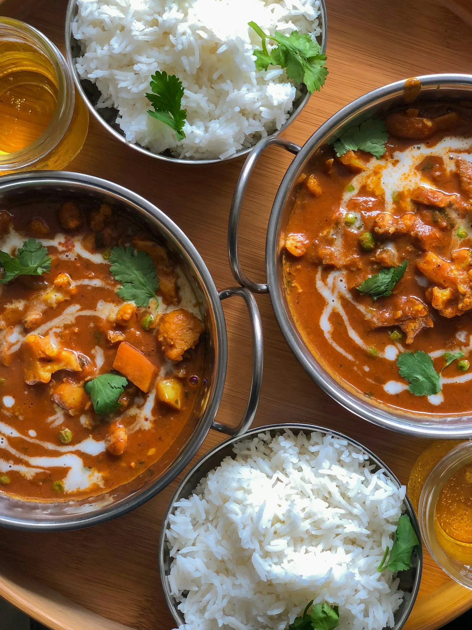 Shared bowls of vegetable curry with rice — plant-forward dishes for communal eating.