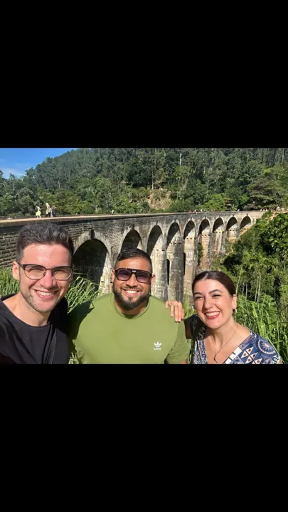 Travellers beside a stone railway viaduct