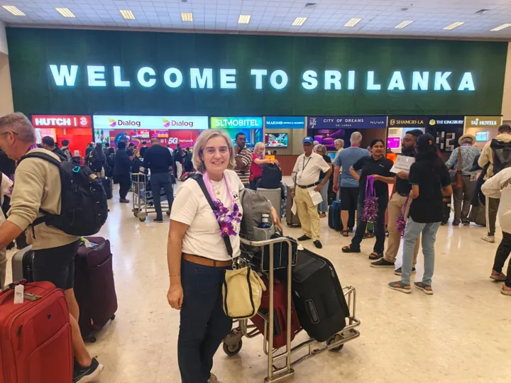 Travellers with luggage at a Sri Lanka airport arrival hall