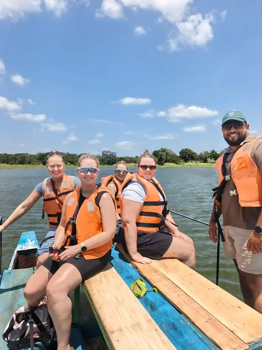 Travellers in life jackets on a boat trip across a lake with Sahan