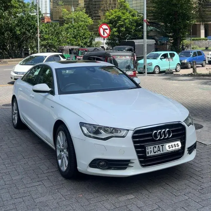 Audi A6 — white car, front and side in daylight