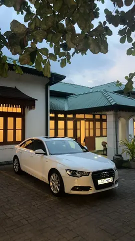 Audi A6 — white car, front and side in the evening