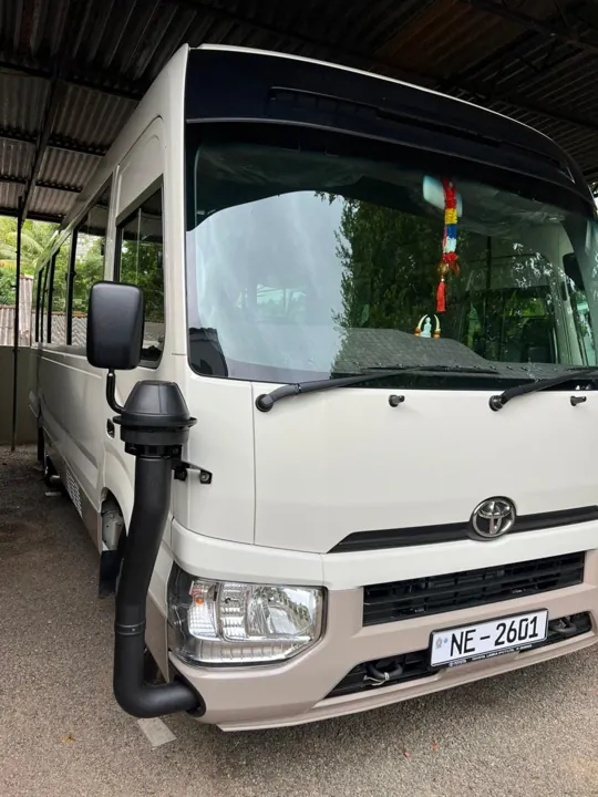 Toyota Coaster — front and side of the minibus