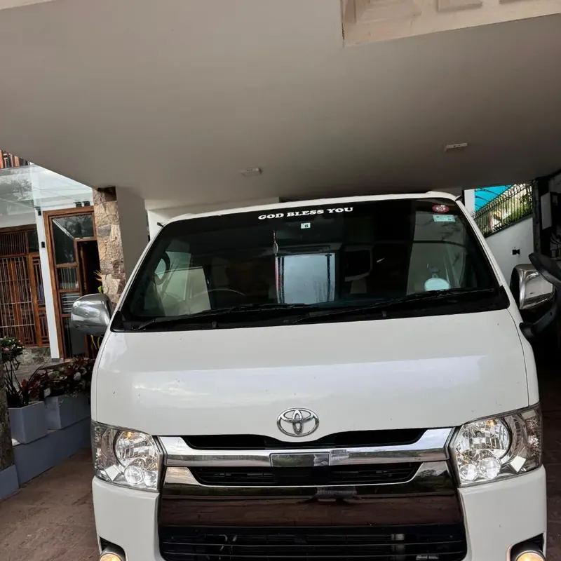 Toyota KDH (white flat roof) — white van, front