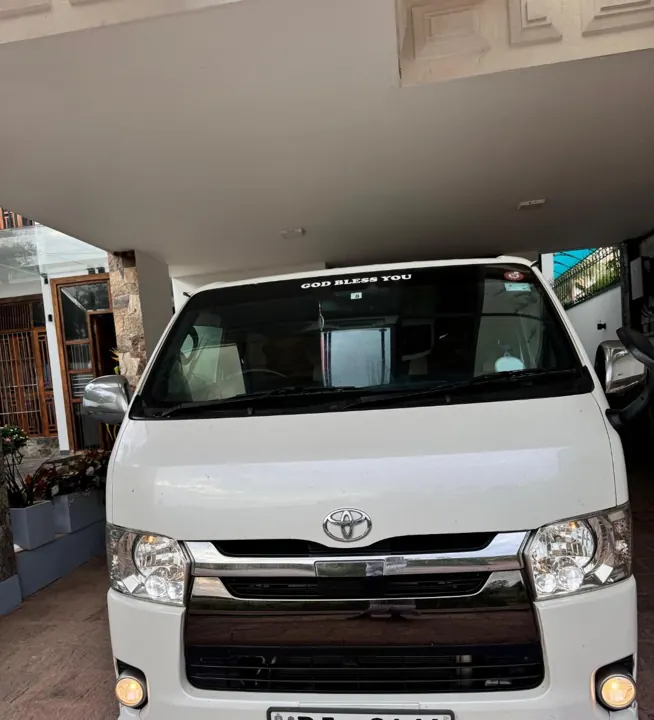 Toyota KDH (white flat roof) — white van, front