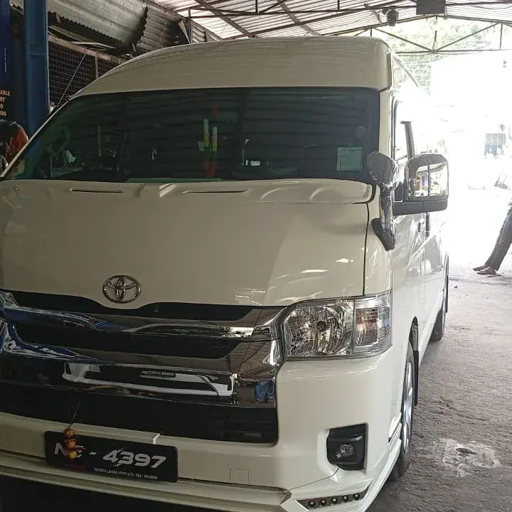 Toyota KDH (white high roof) — white van, front
