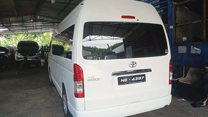Toyota KDH (white high roof) — white van, rear